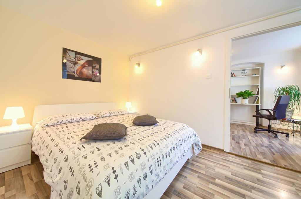 a bedroom with a bed with two pillows on it at Apartment City Center in Rijeka