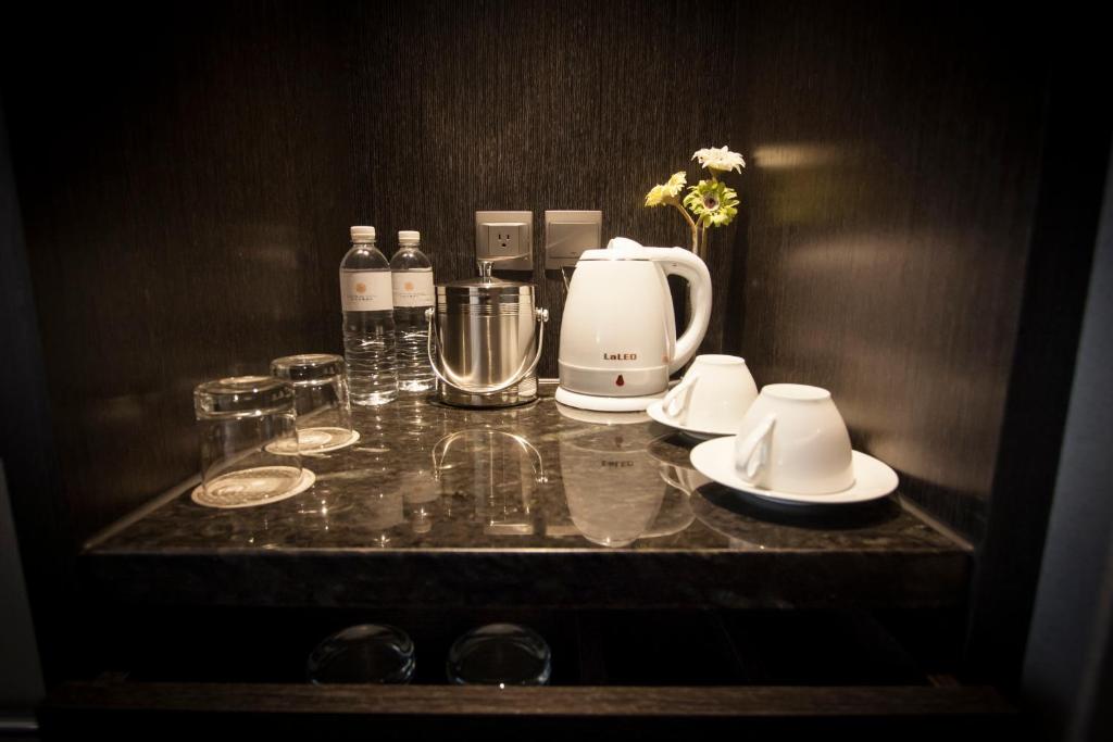 a counter with a coffee maker and glasses on it at Platinum Hotel in Xindian