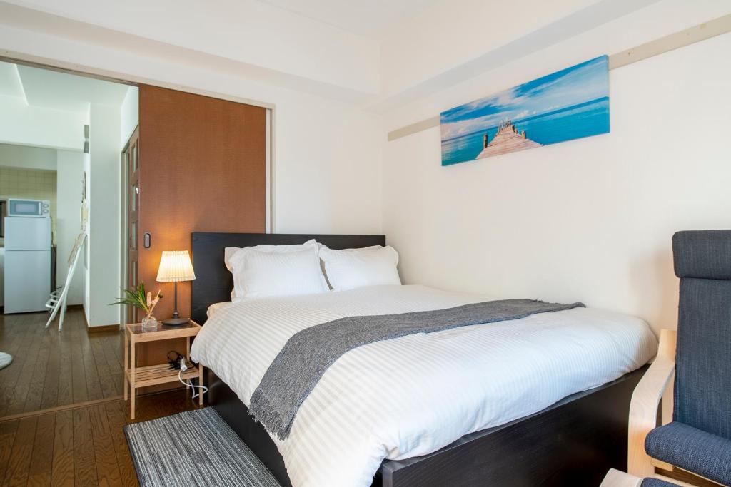 Postel nebo postele na pokoji v ubytování Uhome Akihabara Apartment 3