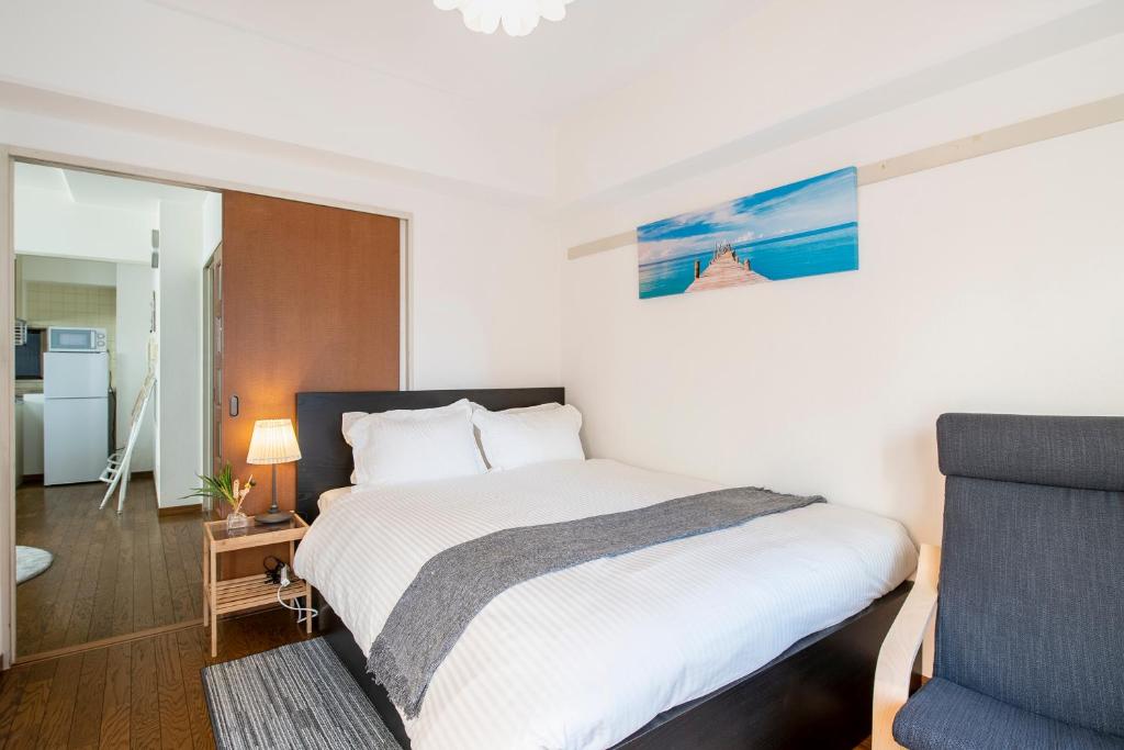 Postel nebo postele na pokoji v ubytování Uhome Akihabara Apartment 3