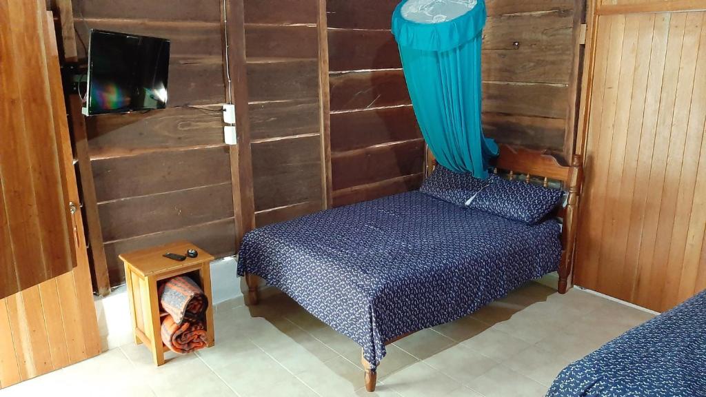 a small room with a bed and a table at Cabanas chaac calakmul in Xpujil