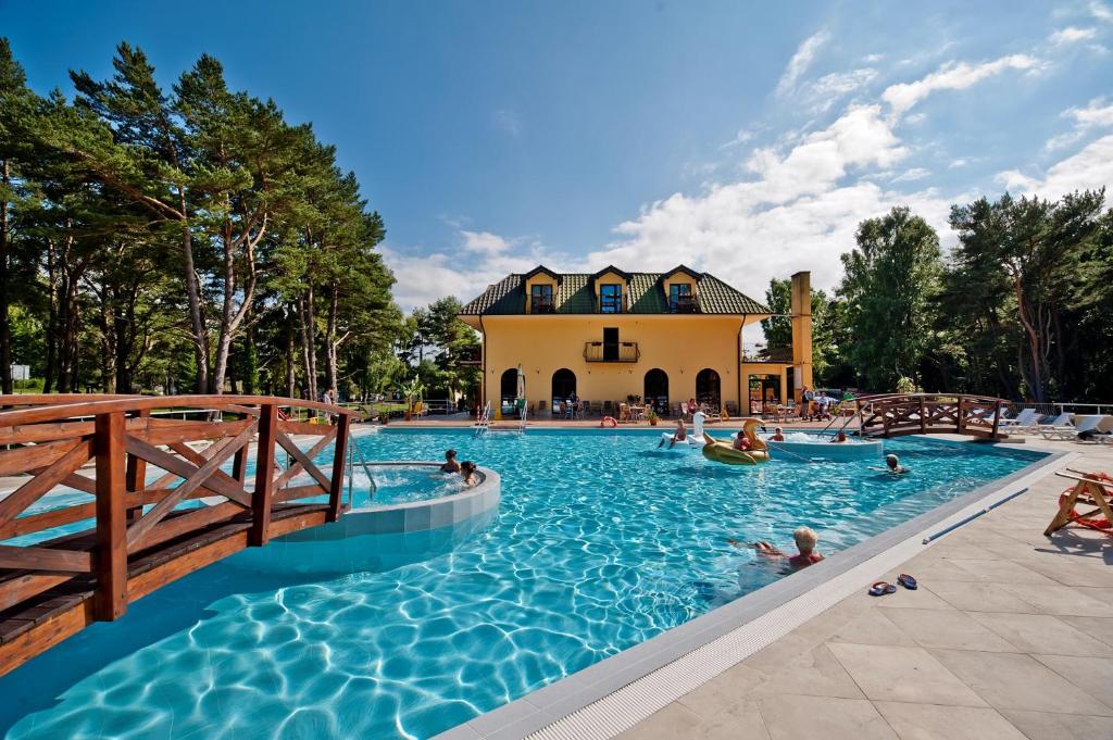 a large swimming pool with people in the water at Ośrodek Zacisze in Rozewie