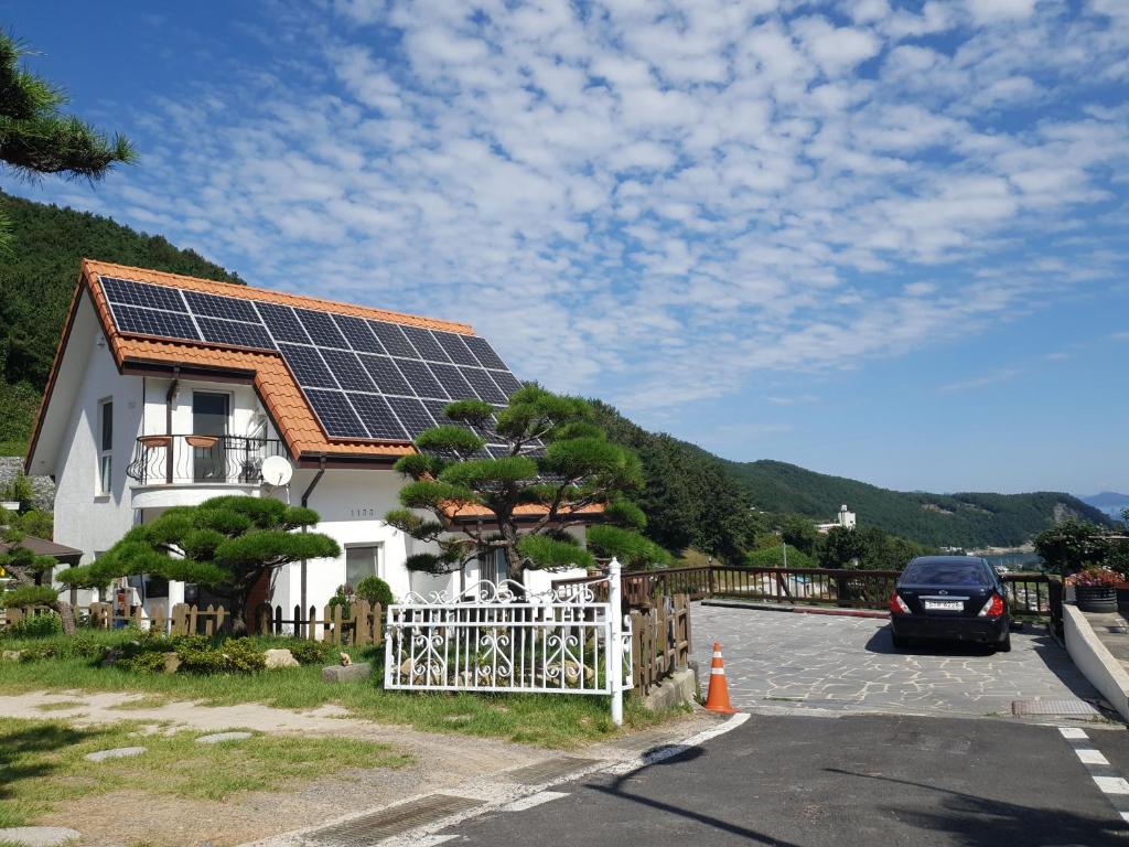 a house with solar panels on the roof at Namhae Neuhaus in Namhae