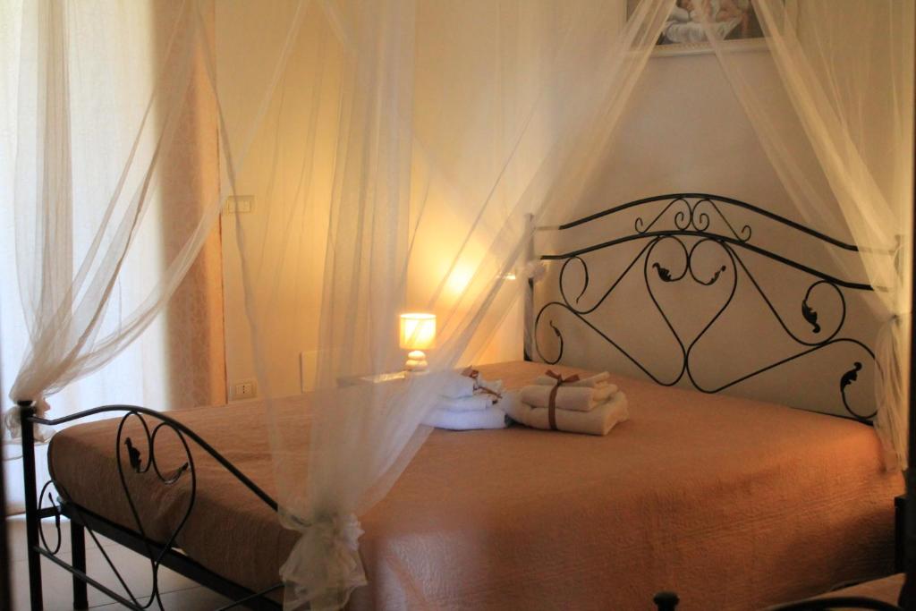 a bedroom with a bed with a white canopy at Gio.Ele in Melendugno