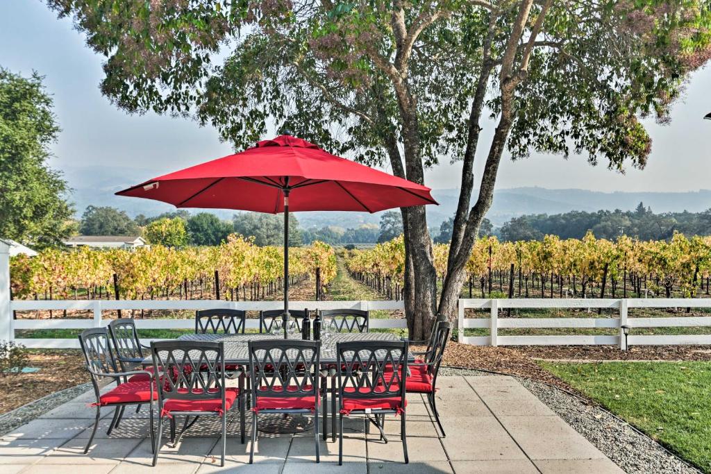 a table and chairs with a red umbrella at Beautiful Sonoma House with Patio and Vineyard Views! in Sonoma