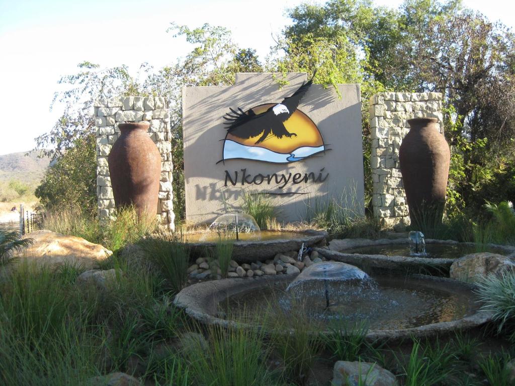 a sign at the entrance to a zoo with a fountain at Nkonyeni Lodge & Golf Estate in Ngwempisi