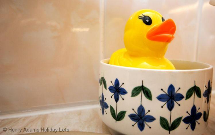a rubber duck in a cup with blue flowers at Cullimore, West Wittering in West Wittering
