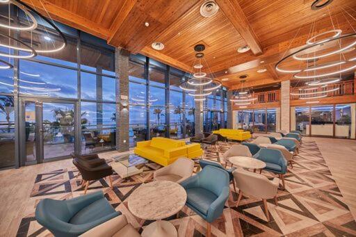 a large room with chairs and tables and windows at Sandos Papagayo in Playa Blanca