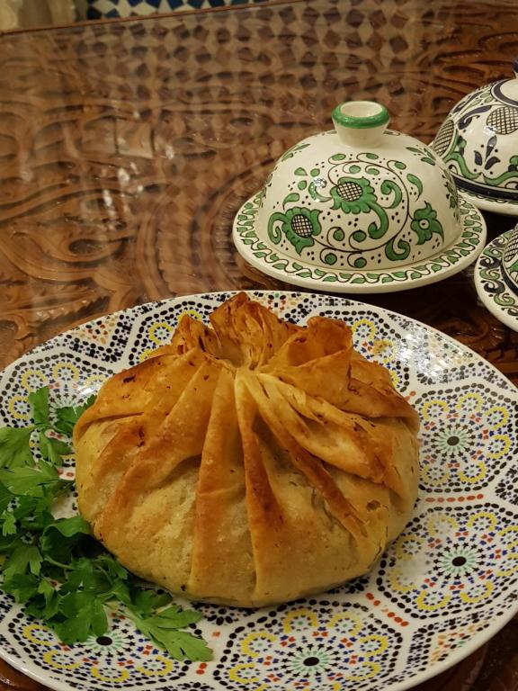 a table with a plate of food on a table at Riad Fes Kettani in Fez