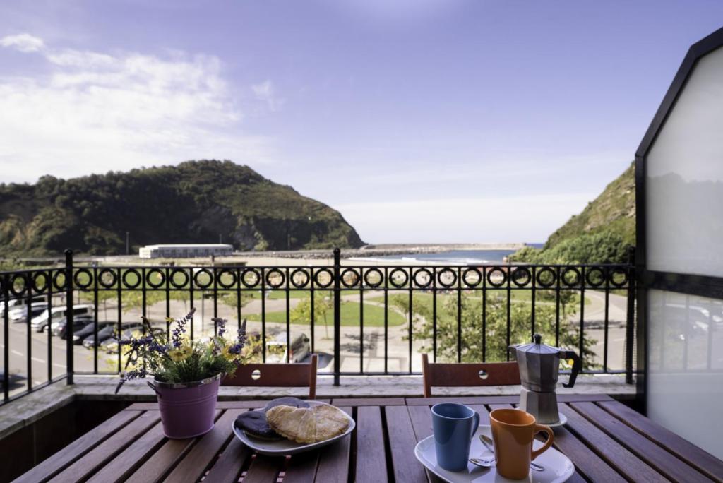 a table with two plates of food on a balcony at Apartamento Balea VII in Orio