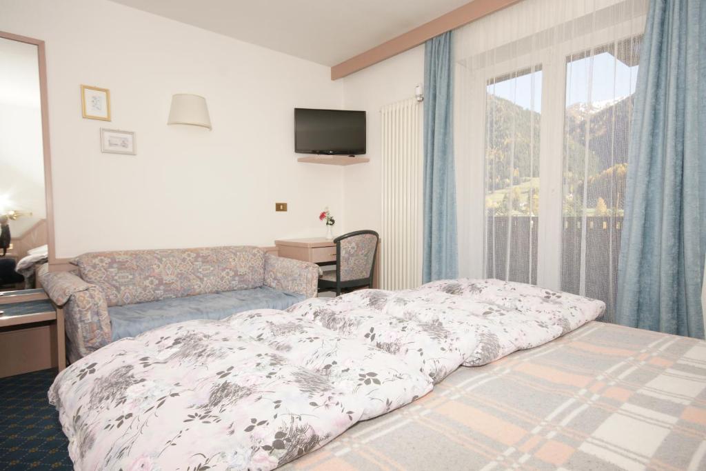 Postel nebo postele na pokoji v ubytování Hotel Villa Mozart