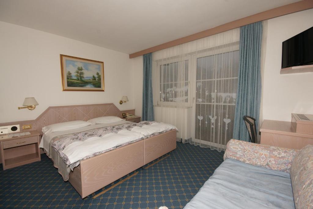 Postel nebo postele na pokoji v ubytování Hotel Villa Mozart