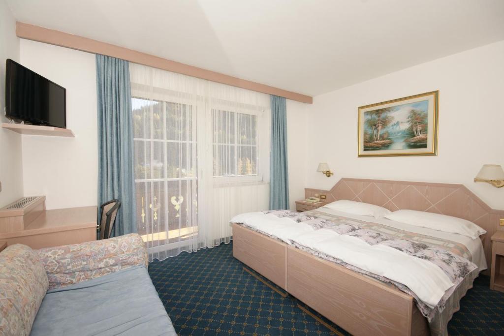 Postel nebo postele na pokoji v ubytování Hotel Villa Mozart