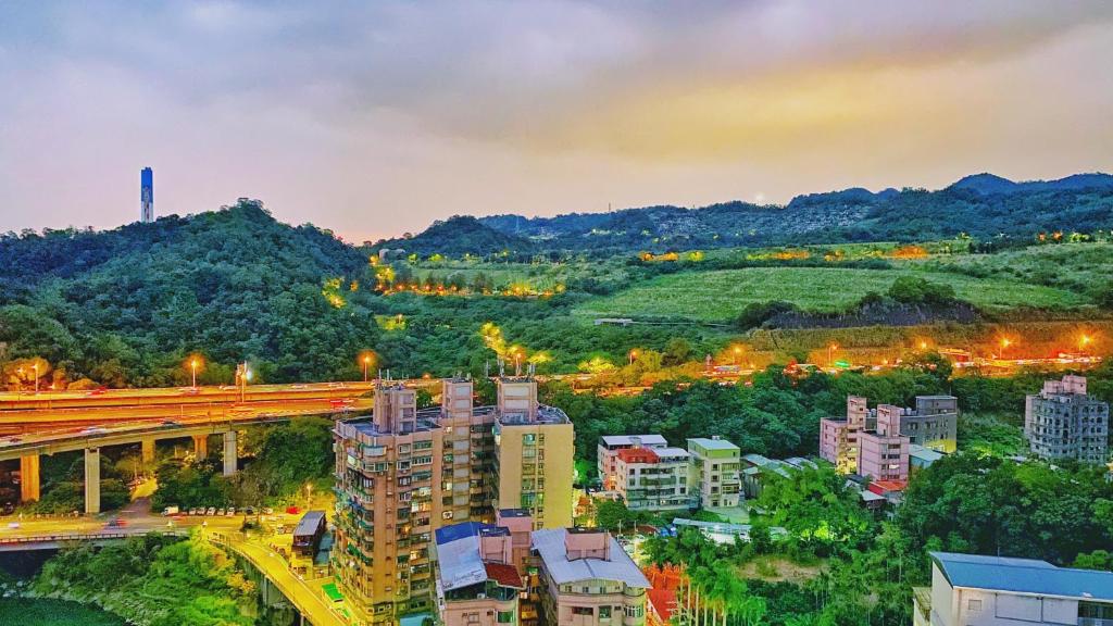 a view of a city with a bridge and buildings at HiONE Holiday Hotel in Shenkeng