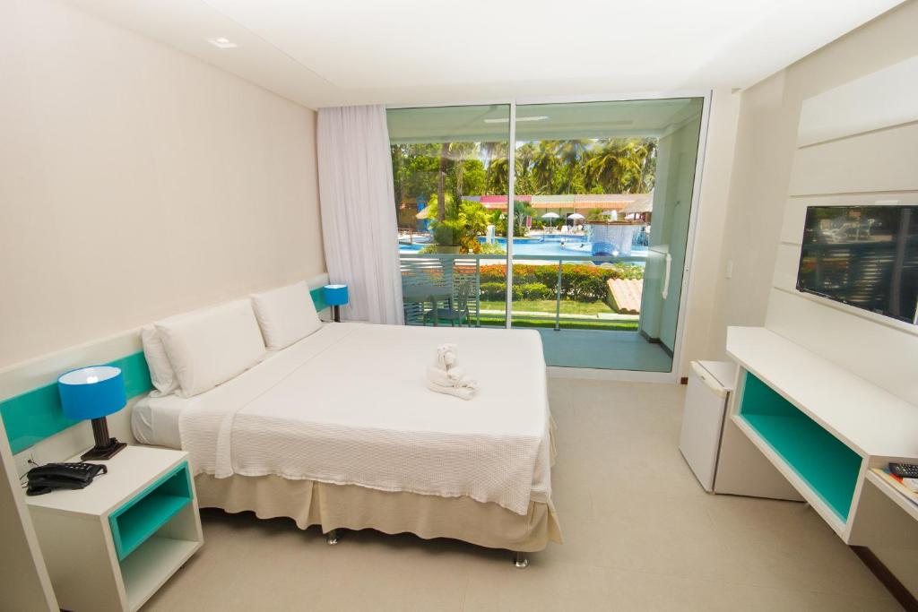 Postel nebo postele na pokoji v ubytování Hotel Praia Dourada
