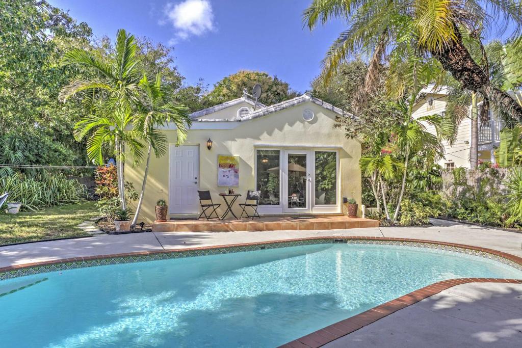 a house with a swimming pool in front of a house at Tranquil West Palm Beach Getaway Walk to Beach! in West Palm Beach