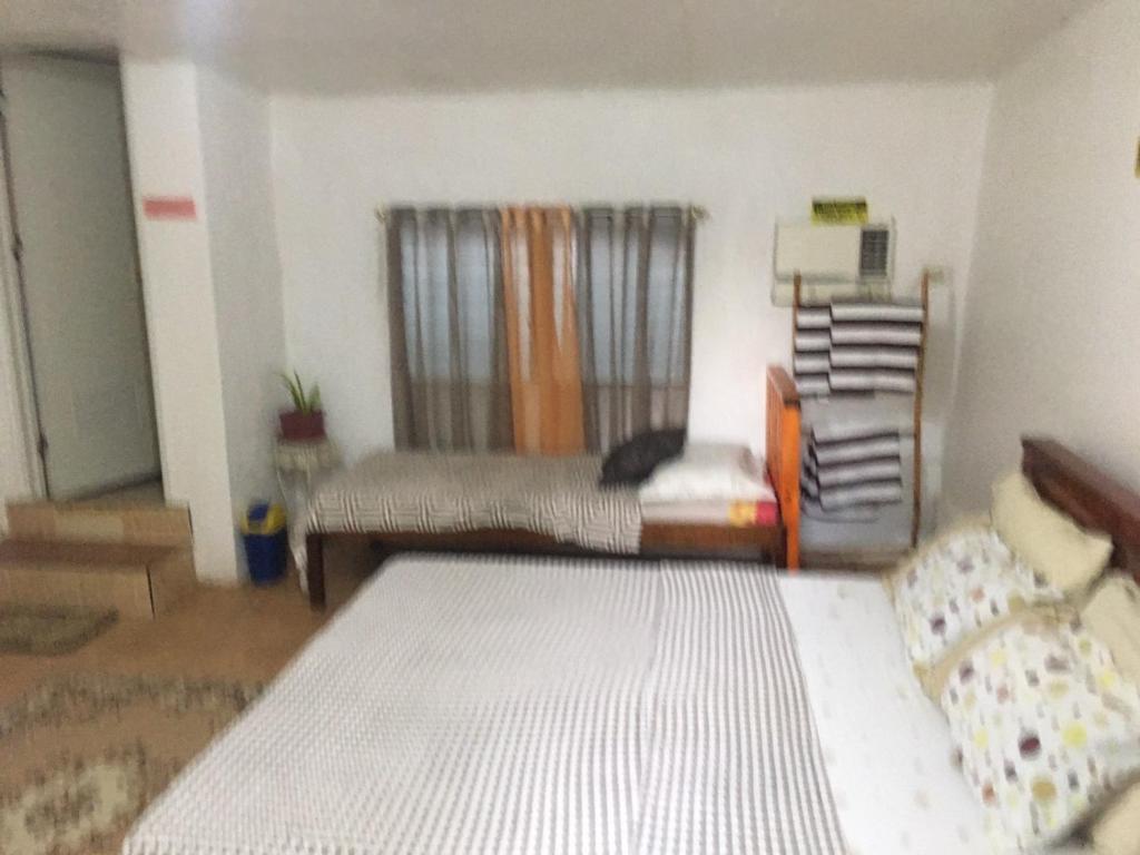 a bedroom with a bed and a couch in it at D & N LODGE in Daanbantayan
