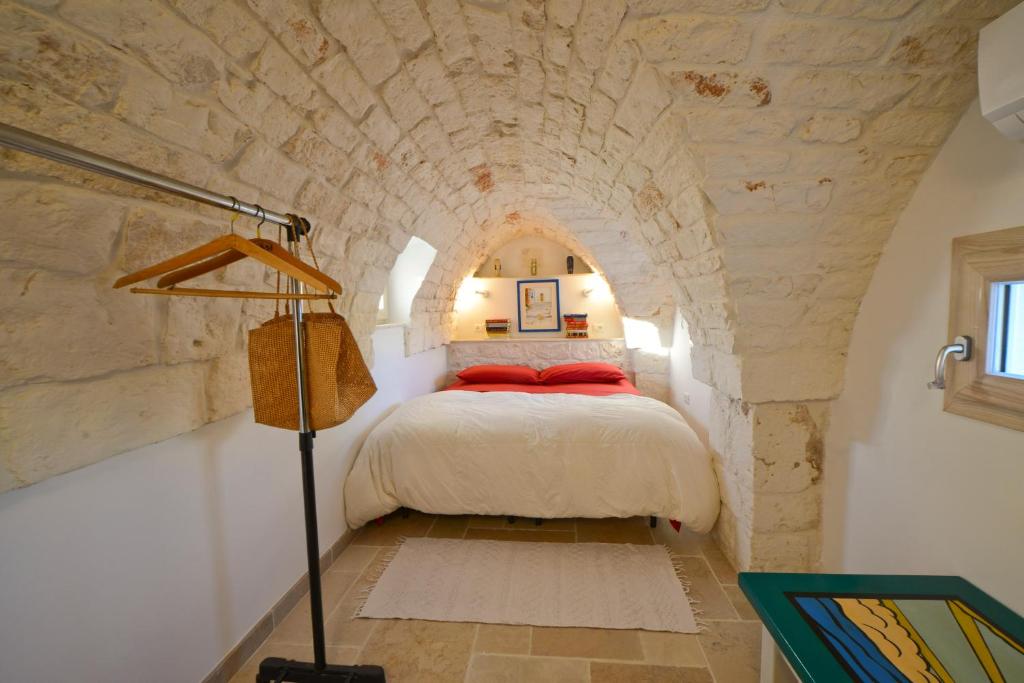 A bed or beds in a room at Ostuni Guest House