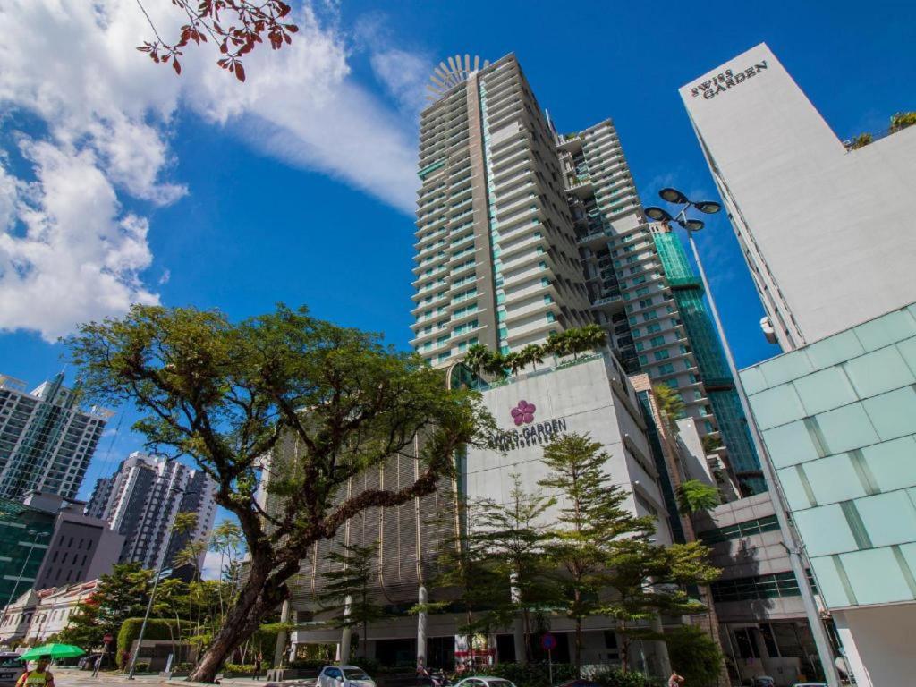 a city skyline with tall buildings and a tree at Apex Cozy Suites at Swiss Garden Residence Kuala Lumpur in Kuala Lumpur