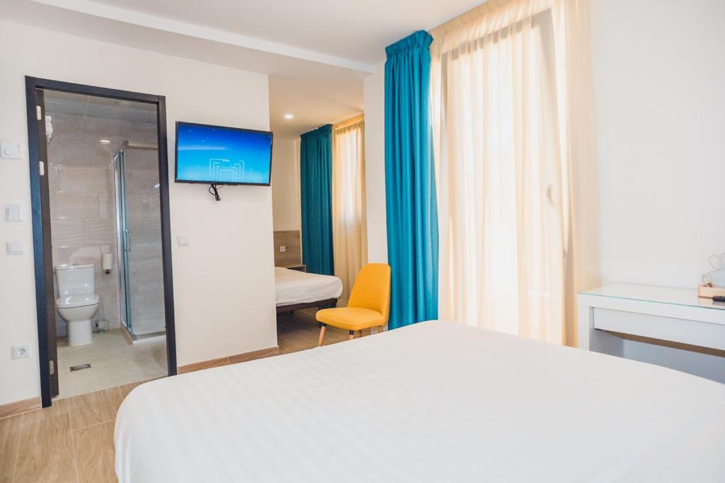 a hotel room with a bed and a bathroom at Solesperit in Lloret de Mar