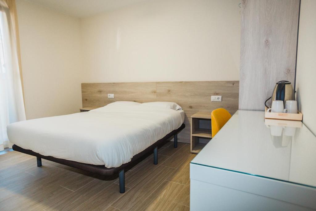 a bedroom with a bed and a dresser and a desk at Solesperit in Lloret de Mar
