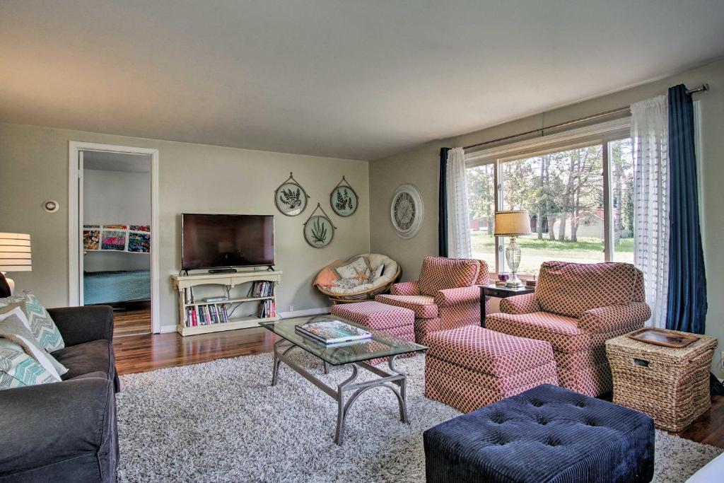 a living room with a couch and chairs and a tv at Scenic Ludington Home about 1 Mile to Lake Michigan in Ludington