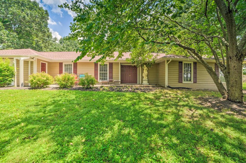 a yellow house with a tree in the yard at Calvert City Home, 8 Miles to Kentucky Lake! in Calvert City