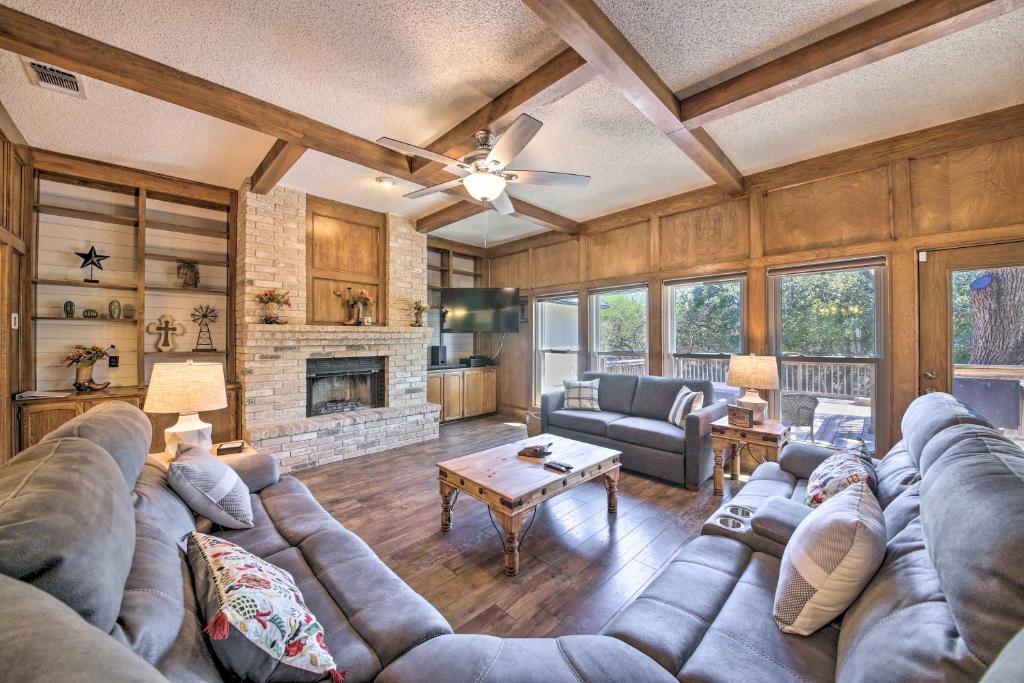a living room with a couch and a fireplace at Family-Friendly Home with Hot Tub, Fire Pit and Deck! in San Antonio