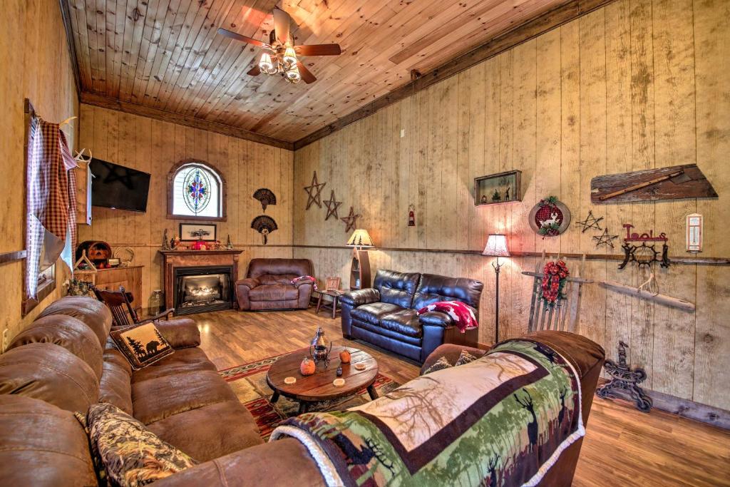 a living room with leather couches and a fireplace at The Bovard Lodge Rustic Cabin Near Ohio River! in Florence
