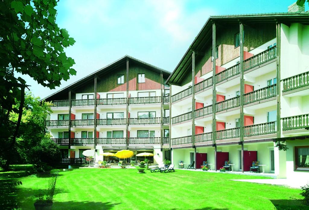 a large building with a lawn in front of it at Hotel Garni Hubertushof in Bad Füssing