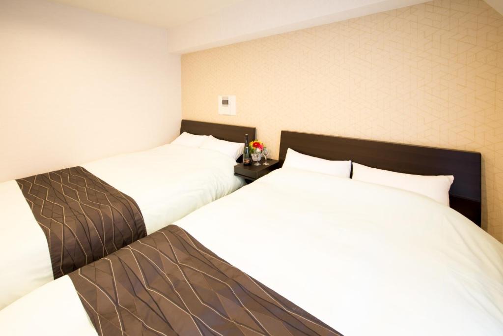 two beds sitting next to each other in a room at Osaka - Hotel / Vacation STAY 65262 in Osaka