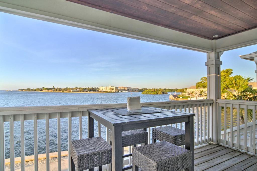 a table on a porch with a view of the water at Bayfront Condo 3 Mi to Downtown St Petersburg in St Petersburg