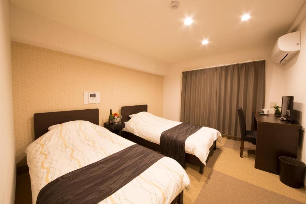 a hotel room with two beds and a desk at Osaka - Hotel / Vacation STAY 65249 in Osaka