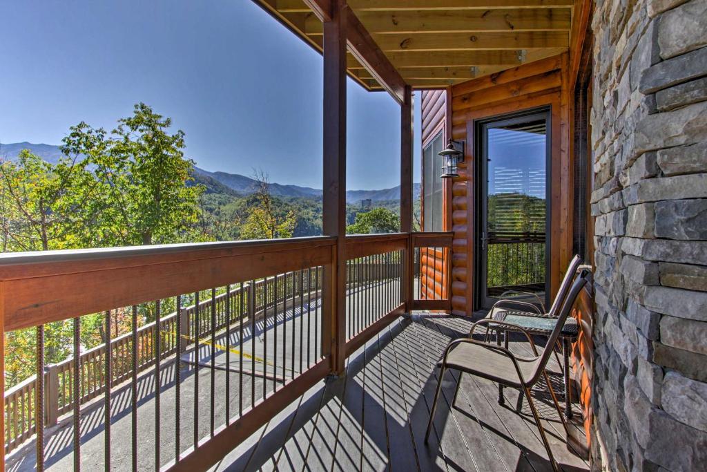 a balcony with a bench and a view of the mountains at Majestic Mtn Getaway Game Room, Decks and Hot Tub! in Gatlinburg