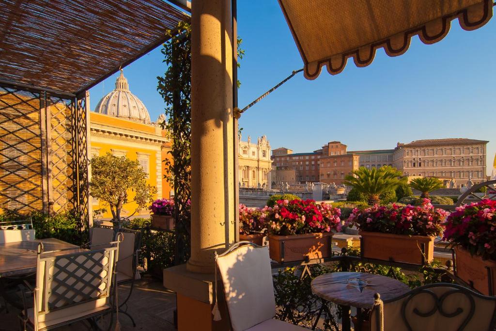 a view of a city from a patio with flowers at Residenza Paolo VI in Rome