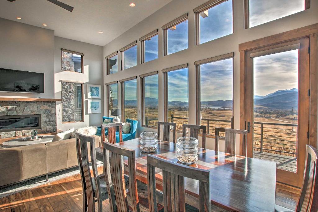 a dining room with a table and chairs and windows at Modern Mountain-View Townhome Less Than 7 Mi to Ski Resorts in Eden