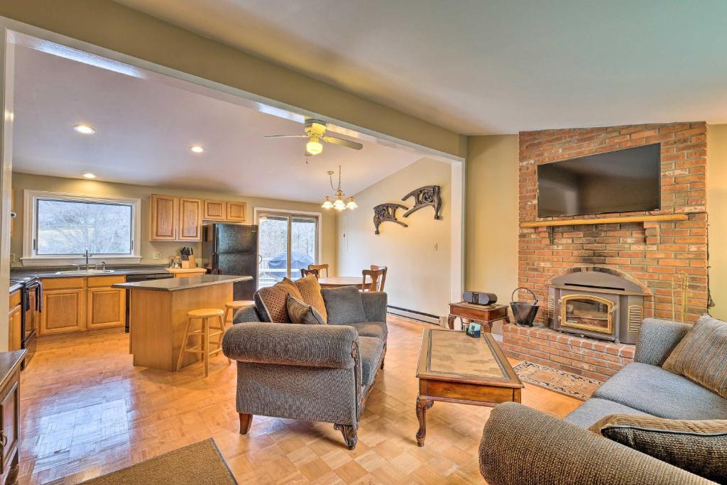 a living room with a couch and a fireplace at Quiet Catskills Getaway with Deck-Panoramic Mtn Views in New Kingston