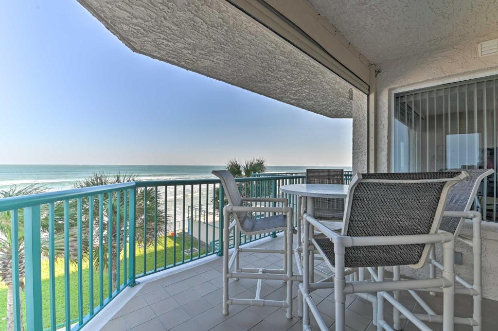 a balcony with a table and chairs and the ocean at Daytona Beach Seaside Condo with Pools and Hot Tubs in Daytona Beach Shores