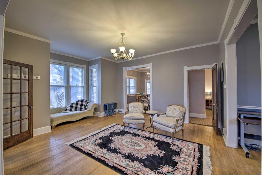 a living room with two chairs and a rug at Historic Noblesville Home Walk to Downtown Shops! in Noblesville