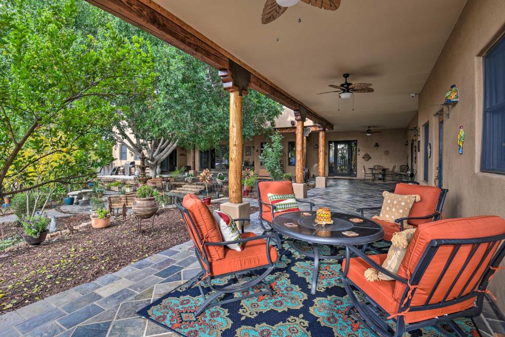 a patio with chairs and a table on a patio at Shared Backyard and Hot Tub Restful Mesa Retreat! in Mesa