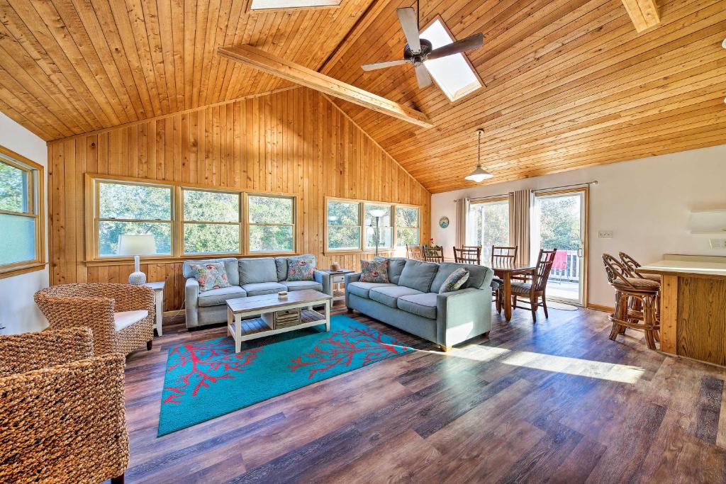 a living room with wood paneling and a ceiling at Bright Southern Shores Family Home Less Than 1 Mi to Beach in Southern Shores