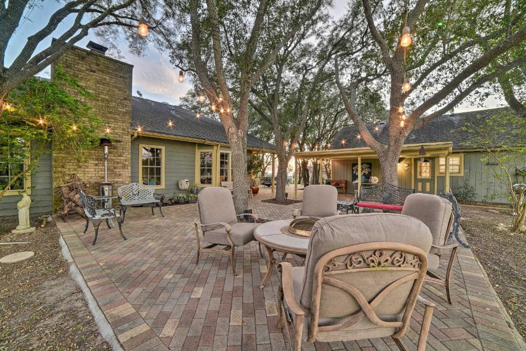 a patio with chairs and tables and a house at Casa de Samuel - Patio, Fountain and Outdoor Kitchen in Corpus Christi