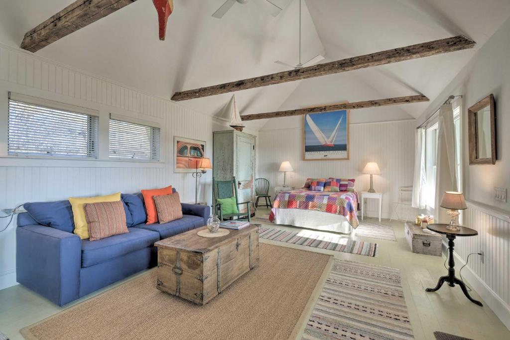 - un salon avec un canapé bleu et un lit dans l'établissement Pauls Cottage in Tenants Harbor, 1 Min to Shore, à Tenants Harbor