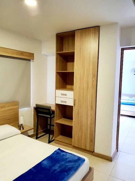 Postel nebo postele na pokoji v ubytování HOTEL MEDELLIN CENTRAL