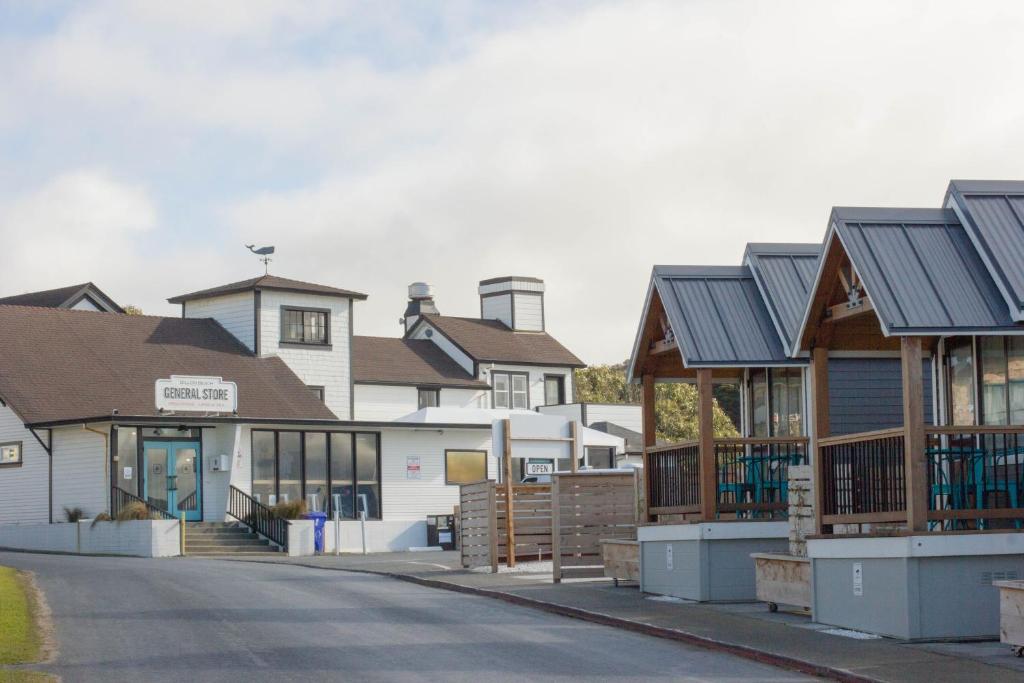 a row of houses with metal roofs on a street at Dillon Beach Resort in Dillon Beach