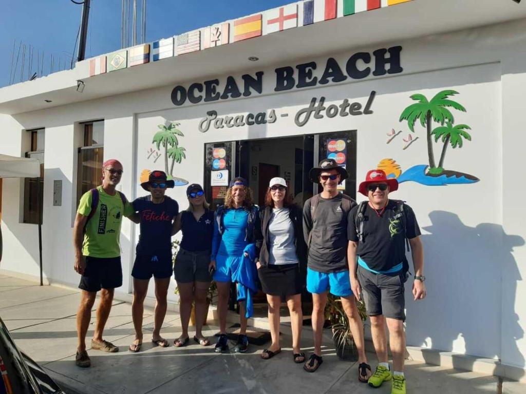 a group of people standing in front of a seafood restaurant at Hotel Ocean Beach Paracas in Paracas