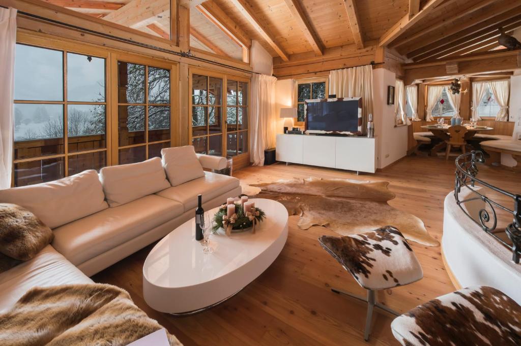a living room with a couch and a table at Das Kitz - deLuxe Chalet Valerie in Reith bei Kitzbühel