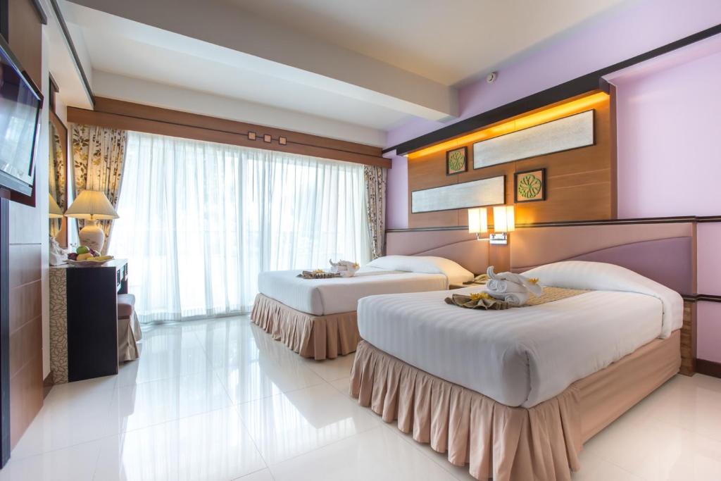 Postel nebo postele na pokoji v ubytování Asia Cha-am Hotel