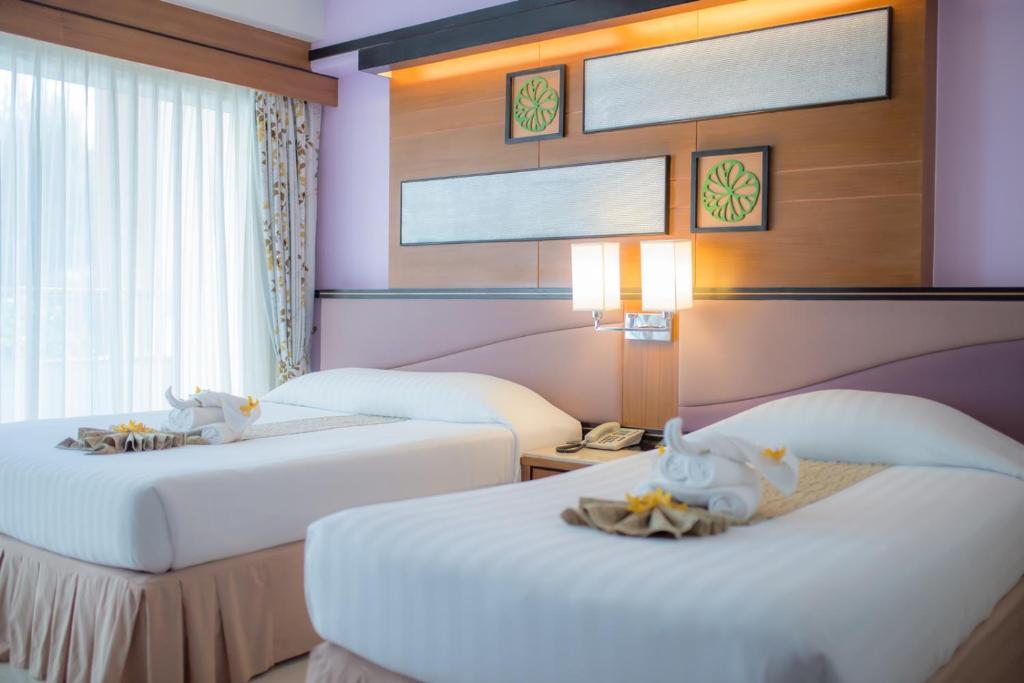 Postel nebo postele na pokoji v ubytování Asia Cha-am Hotel