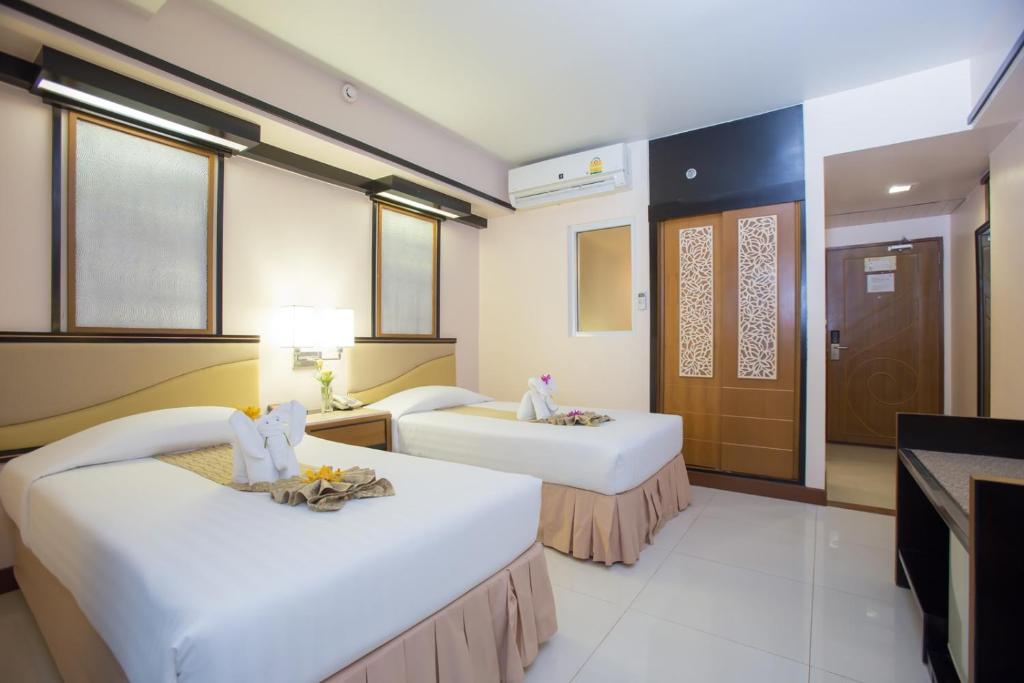 Postel nebo postele na pokoji v ubytování Asia Cha-am Hotel